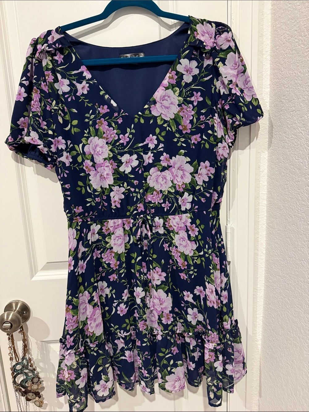 Have some fun in this fully lined v neck flirty floral navy blue dress.